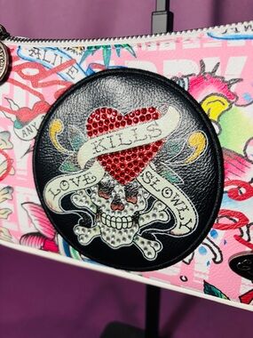 Ed Hardy purse/shoulder bag includes the iconic LOVE KILLS SLOWLY tattoo design.